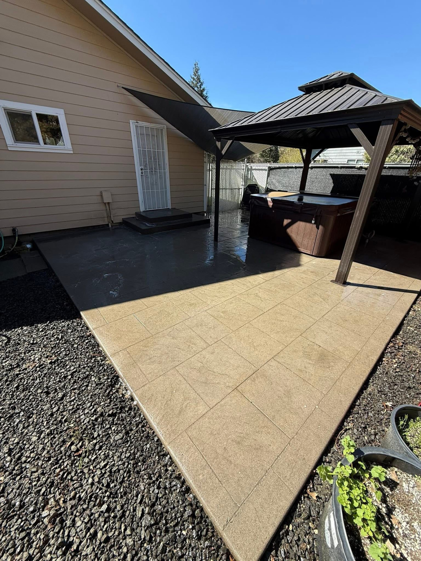 The same stamped concrete patio clean and bright after washing